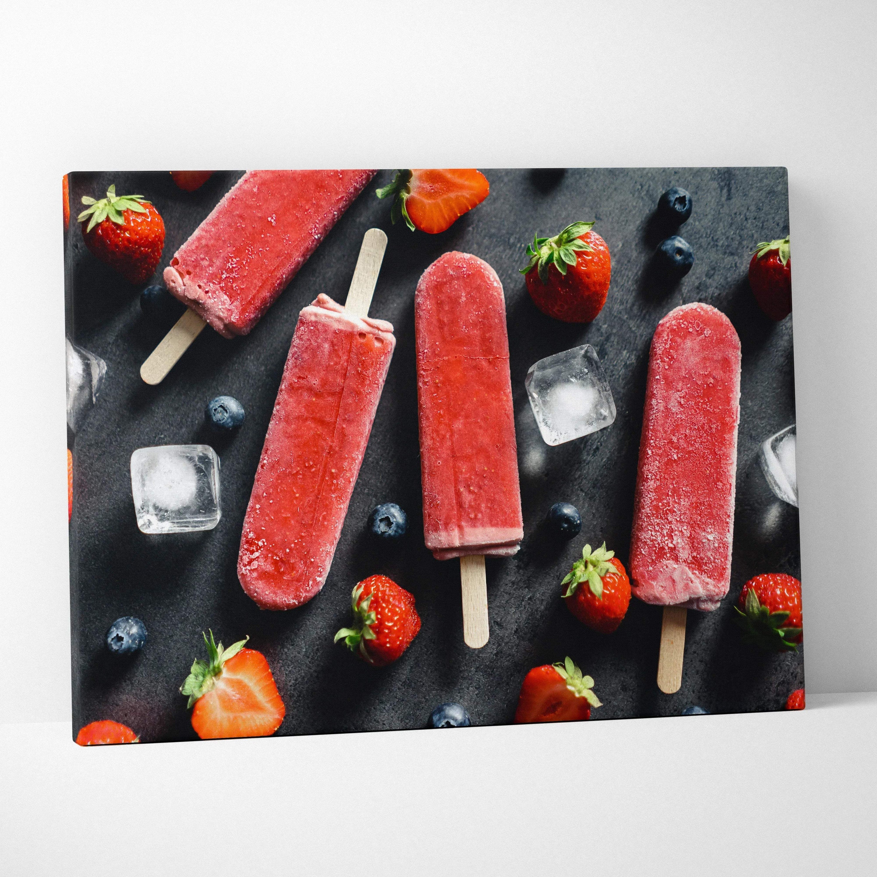 Canvas wall art featuring vibrant red strawberry popsicles with fresh strawberries, blueberries, and ice cubes on a dark.
