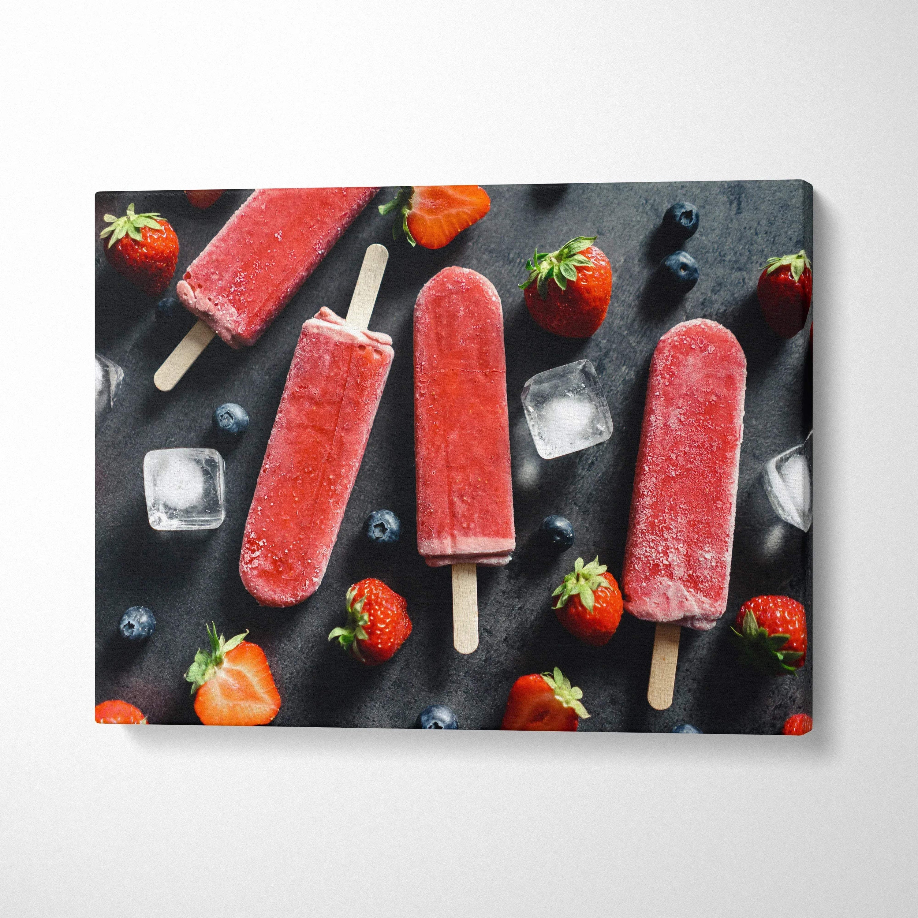 Canvas wall art featuring vibrant red strawberry popsicles with scattered fresh strawberries and ice cubes on a dark.