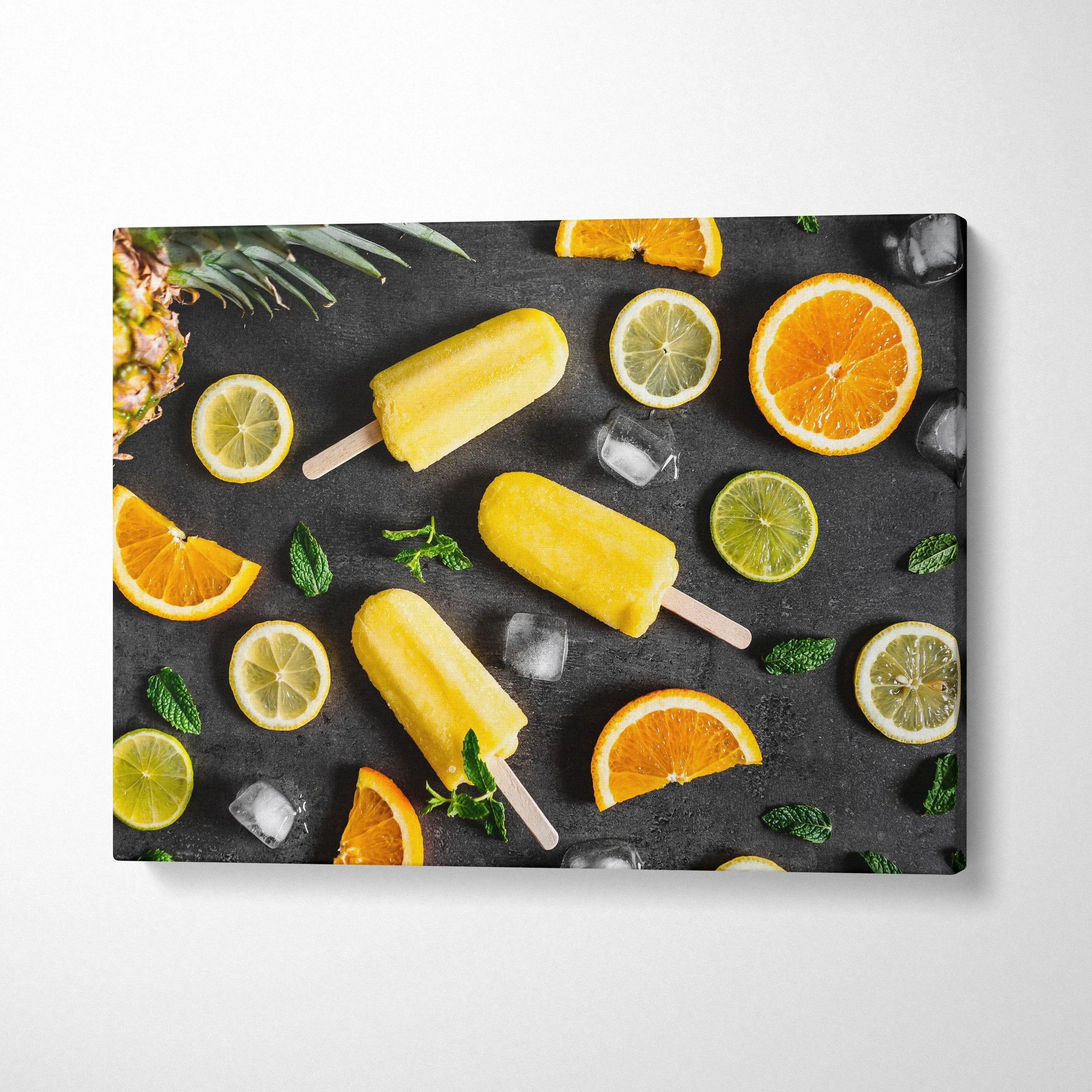 Canvas wall art featuring vibrant yellow popsicles with orange and lime slices on dark background decor.
