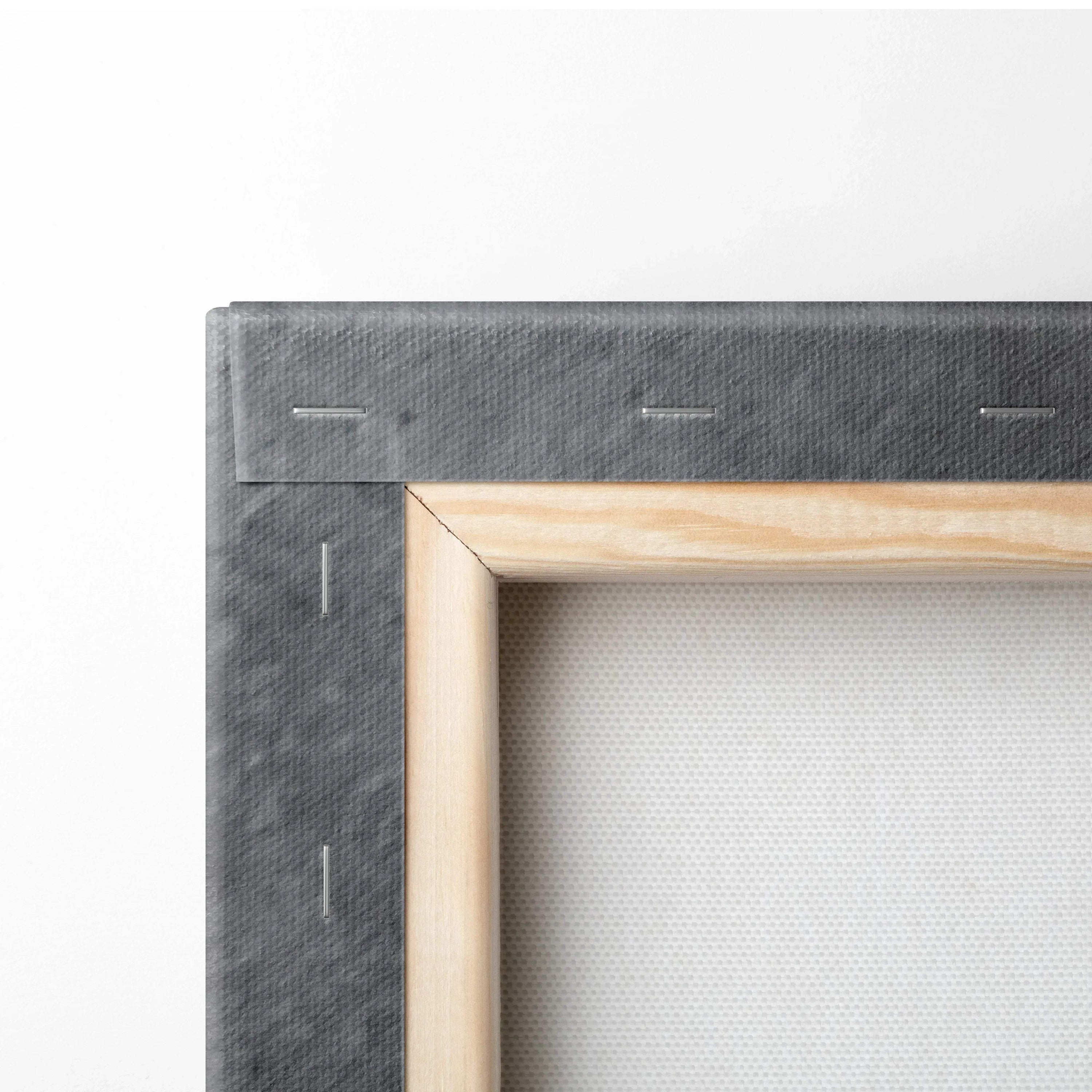 Close-up of wooden frame and stapled edges on blank stretched canvas wall art panel.