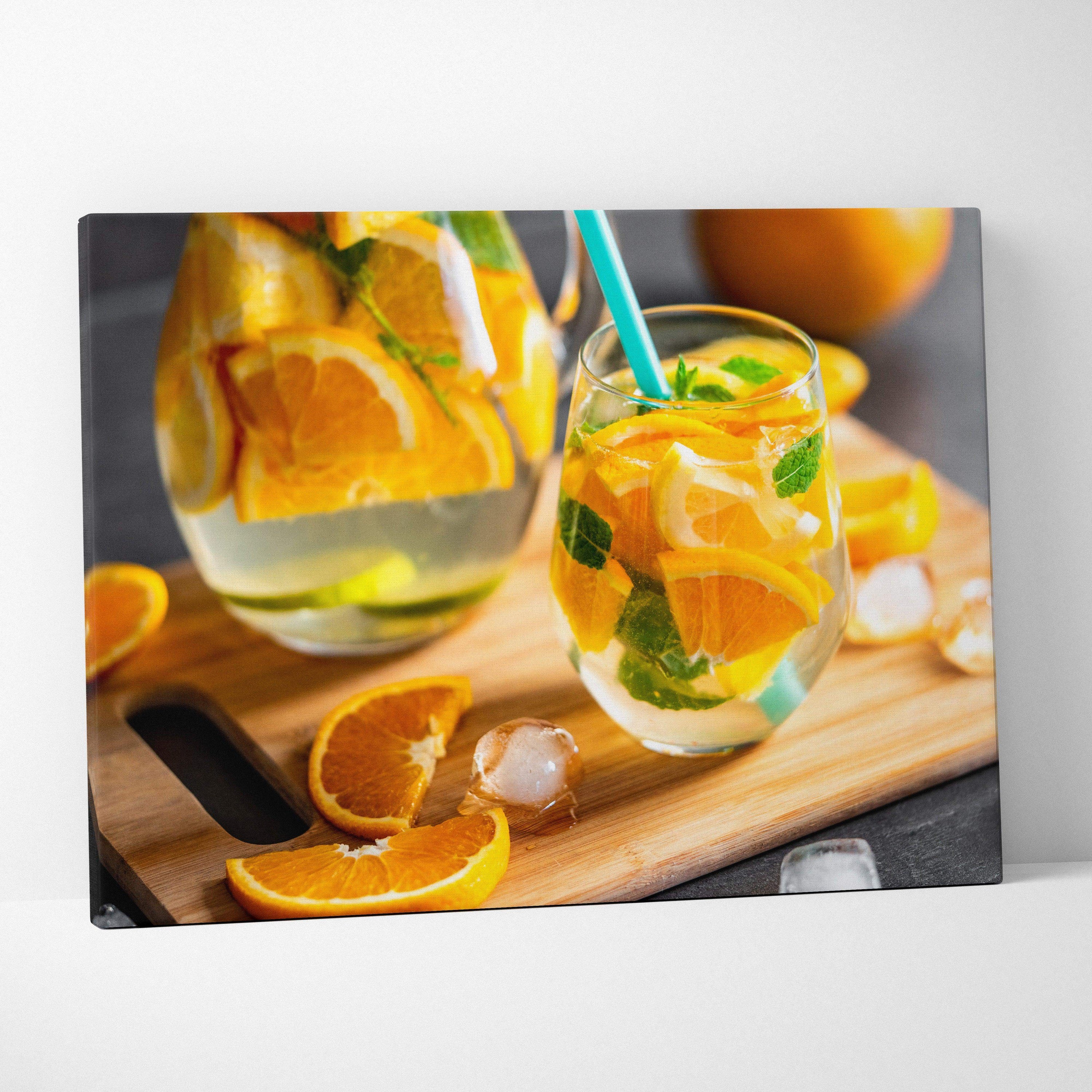 Canvas wall art featuring vibrant sliced oranges and a refreshing citrus drink on a wooden board for modern kitchen decor.
