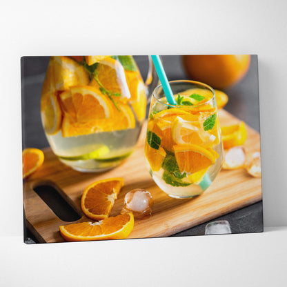Canvas wall art featuring vibrant sliced oranges and a refreshing citrus drink on a wooden board for modern kitchen decor.