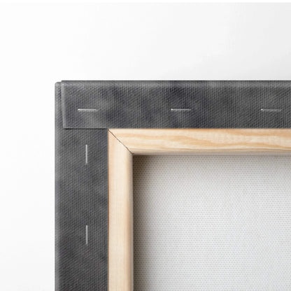 Close-up of wooden frame and canvas texture on wall art decor with staples securing canvas.