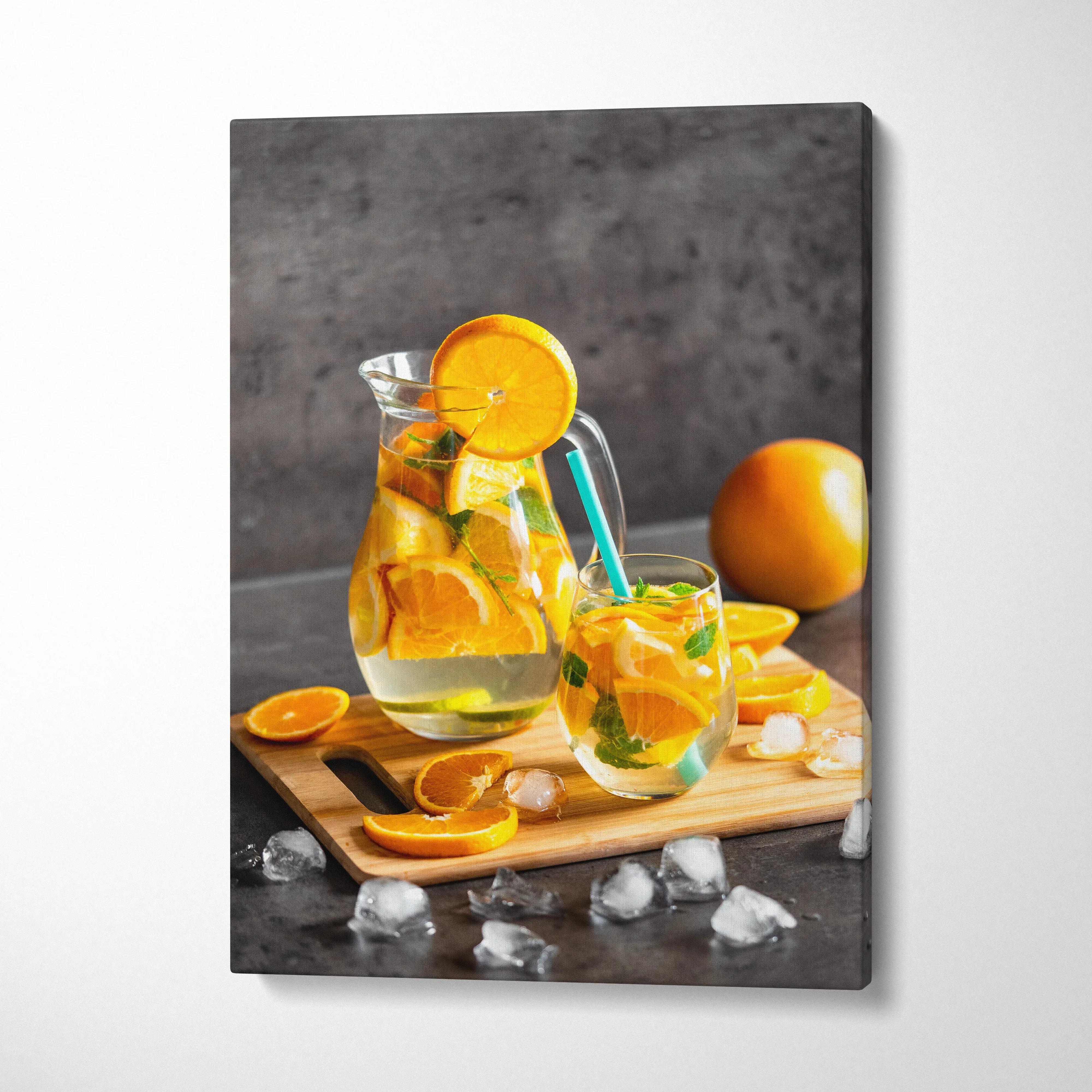 Canvas wall art featuring vibrant fresh orange slices in a water glass on wooden board for kitchen decor.