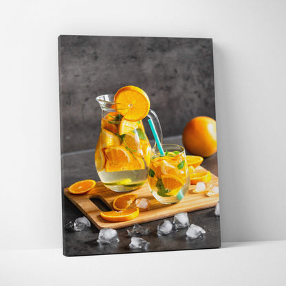 Canvas wall art featuring fresh orange slices in a water glass on a wooden board, vibrant kitchen decor.