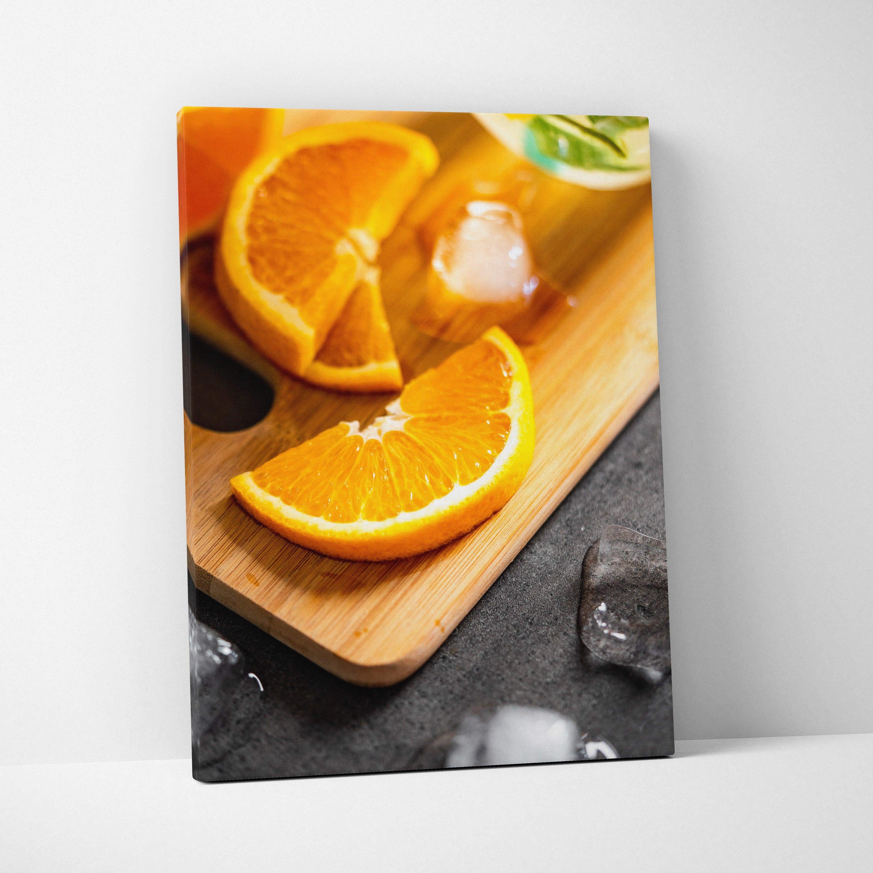 Vibrant orange slices on wooden board canvas wall art with ice cube accents decor.