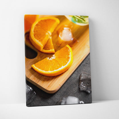 Vibrant orange slices on wooden board canvas wall art with ice cube accents decor.