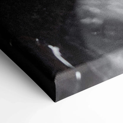 Close-up of black canvas wall art texture with subtle white highlights and wrapped edges.