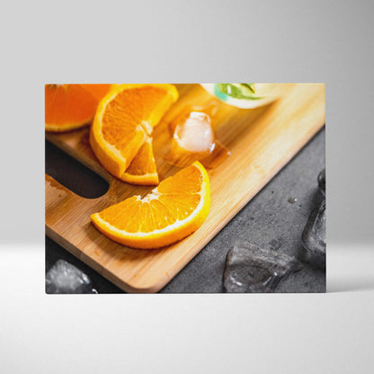 Canvas wall art featuring vibrant sliced oranges on a wooden cutting board for fresh home decor.