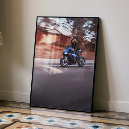 Yamaha R1 motorcycle riding on road poster with blurred autumn trees wall art in black frame.