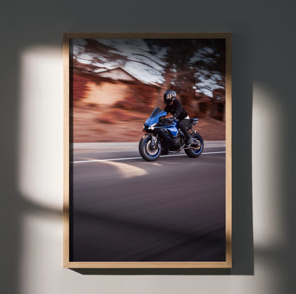 Yamaha R1 motorcycle riding at speed poster wall art in wooden frame with blurred background.