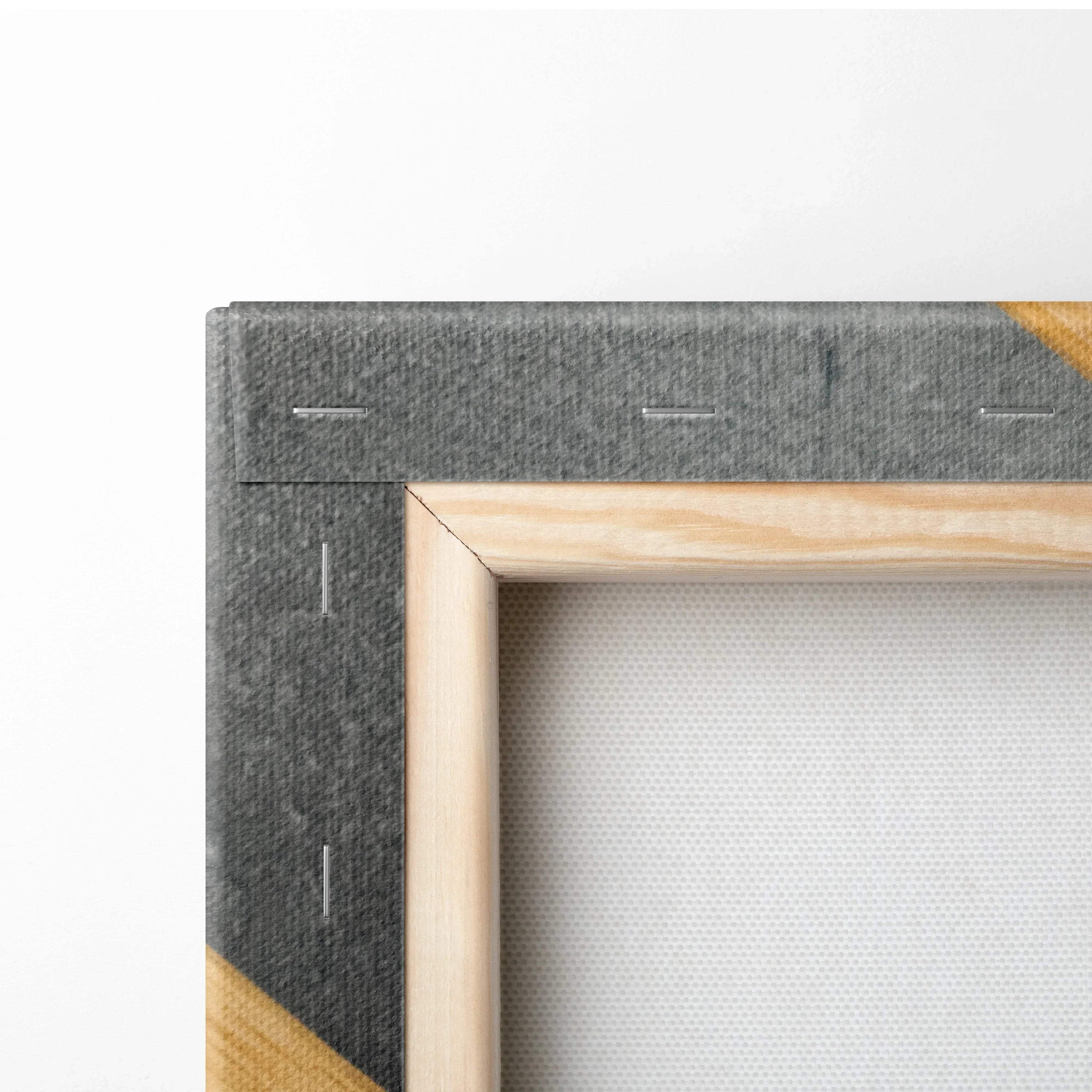 Close-up of wooden frame and gray fabric backing of stretched canvas wall art showing corner details and staples.