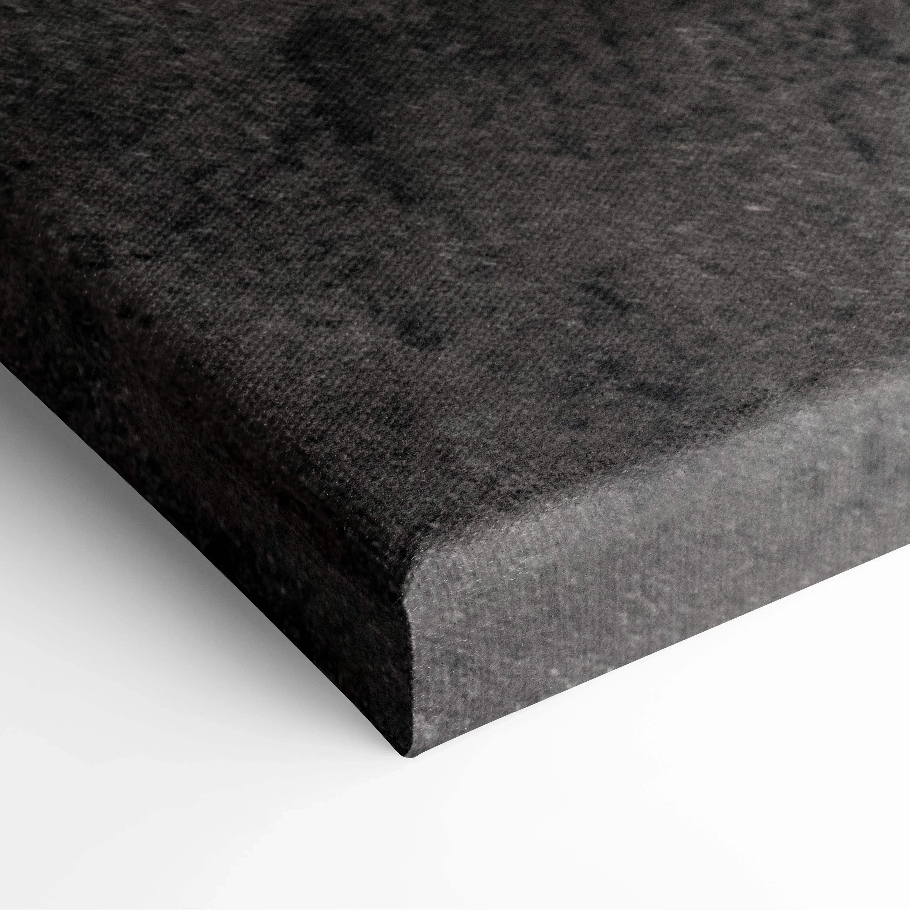 Close-up of thick black canvas edge with textured fabric surface on stretched wall art panel.