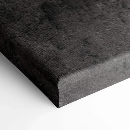 Close-up of thick black canvas edge with textured fabric surface on stretched wall art panel.