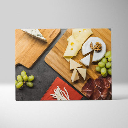 Canvas wall art featuring assorted cheeses, grapes, walnuts, and cured meats on wooden boards.