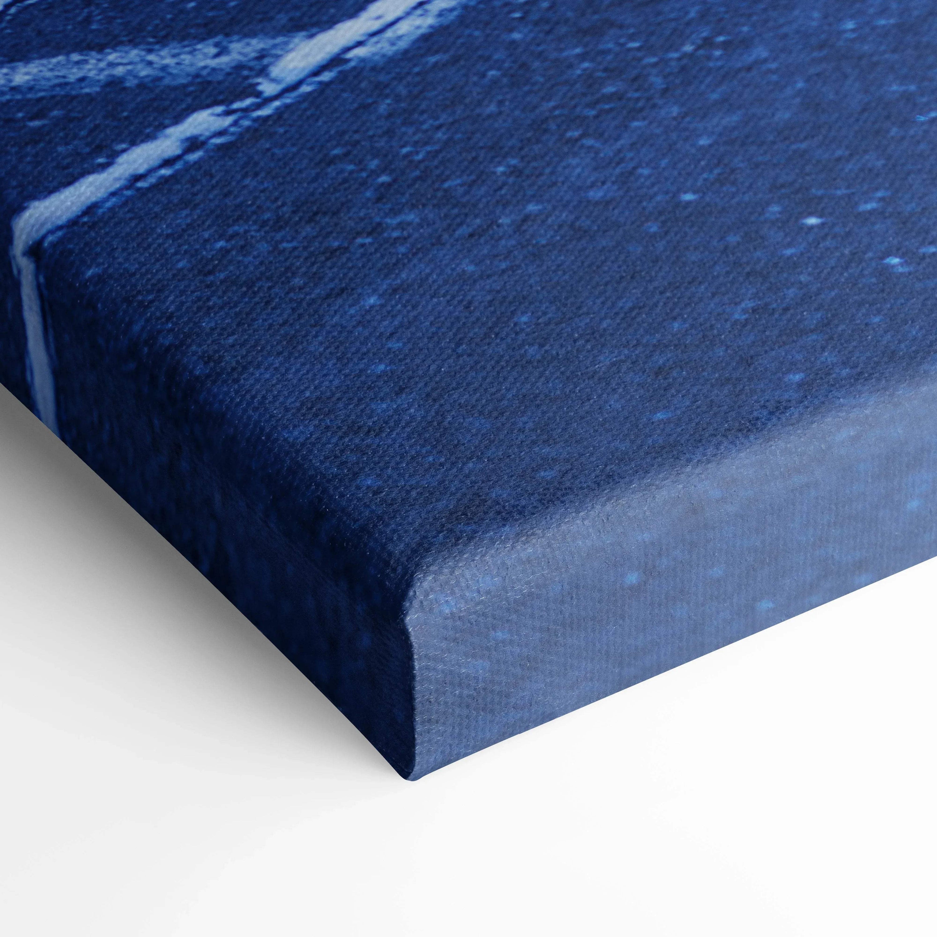 Close-up of blue textured canvas art corner with museum-quality thick edge for vertical wall art display.