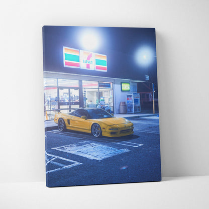 Acura NSX yellow car parked under 7-Eleven sign at night canvas wall art.