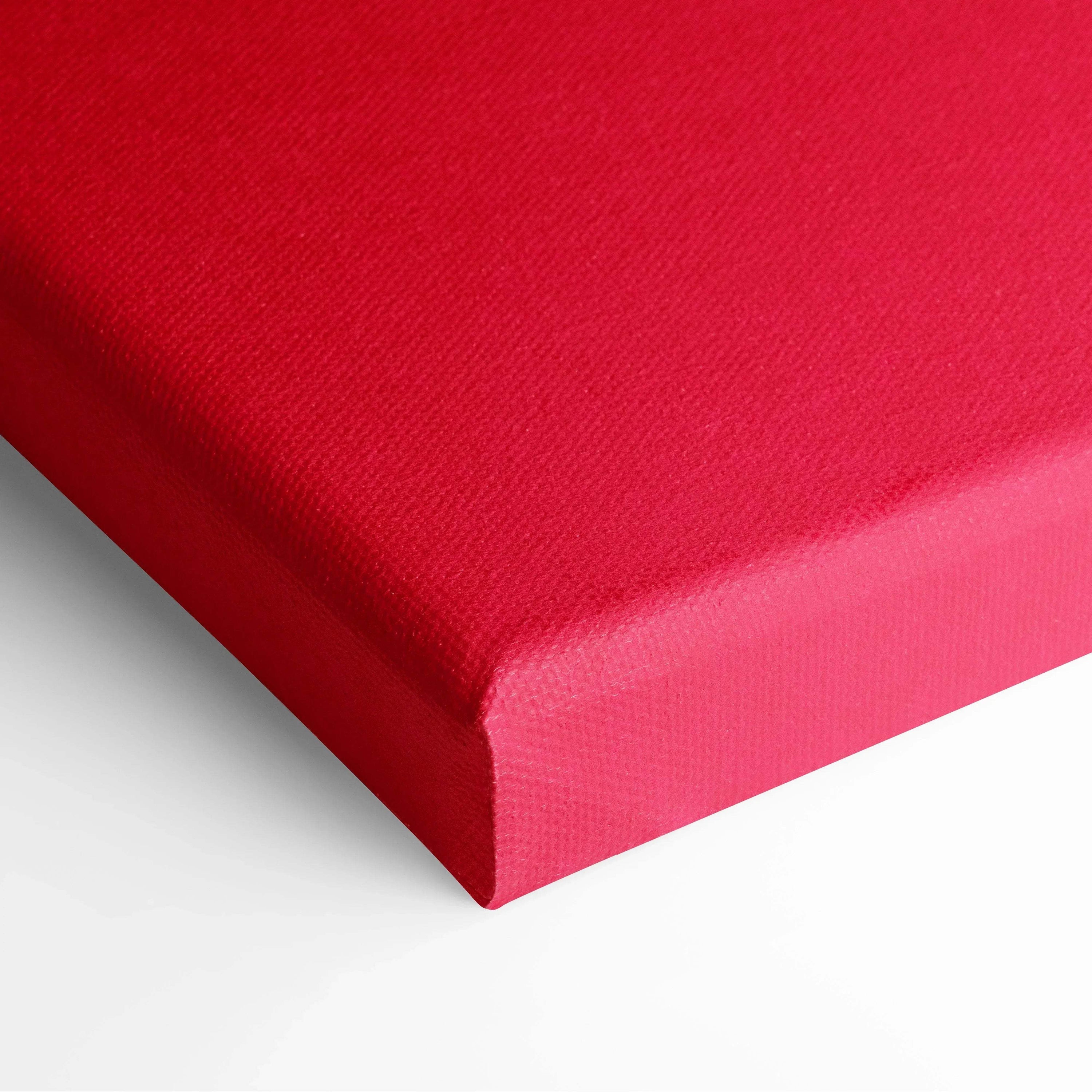 Bold red canvas wall art with smooth texture, vibrant decor piece with wrapped edges.