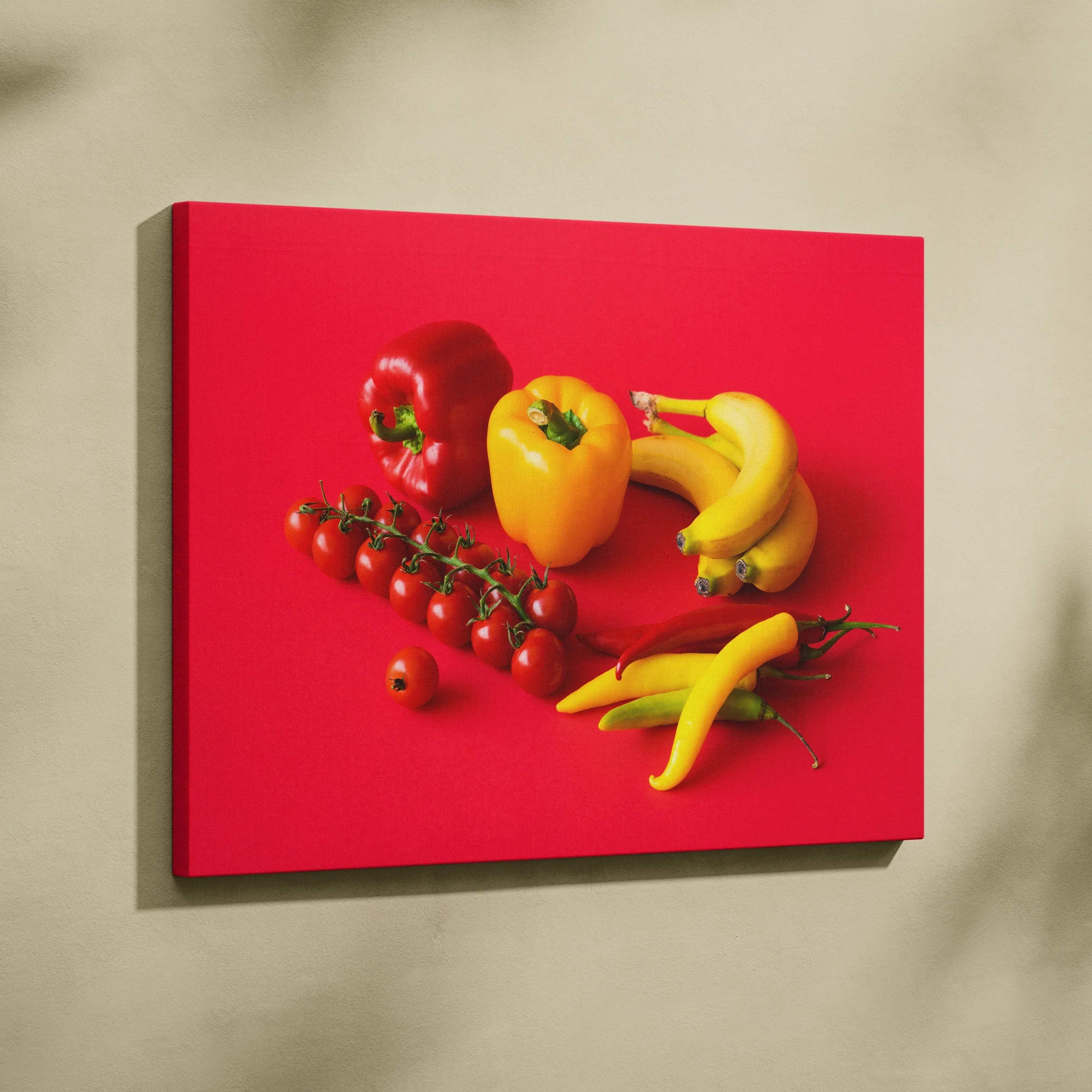 Canvas wall art featuring vibrant bananas, peppers, and tomatoes on bright red background decor.