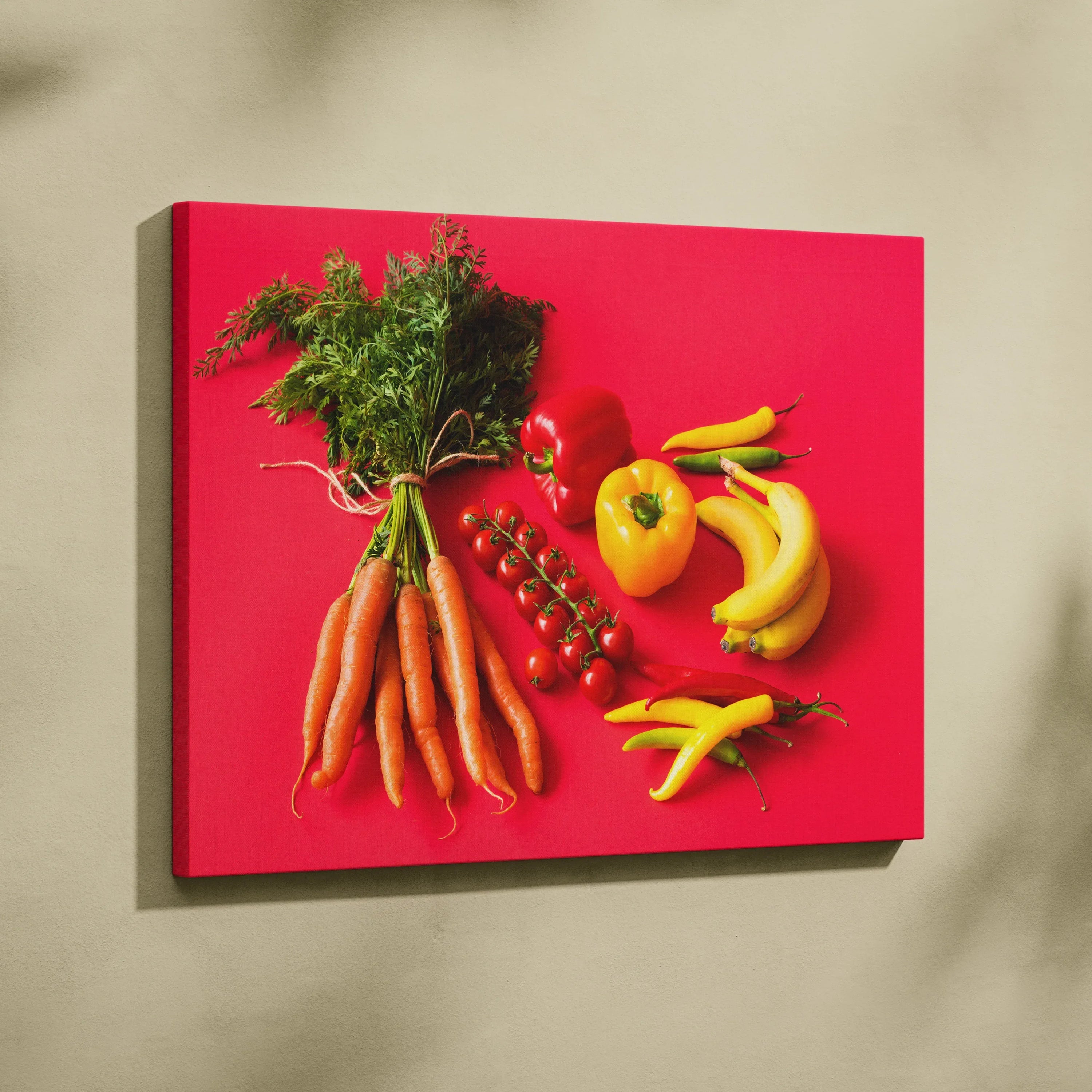 Canvas wall art featuring vibrant carrots, cherry tomatoes, yellow peppers, and bananas on a bold red background decor.