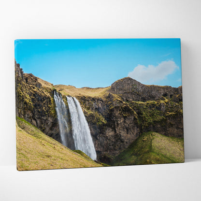 Icelandic waterfall nature landscape canvas wall art with vibrant blue sky and rocky hills decor.