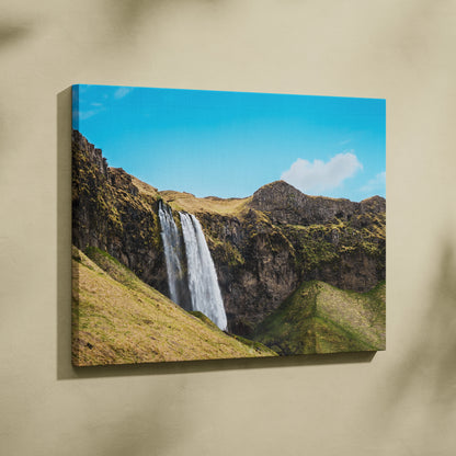 Icelandic waterfall landscape canvas wall art with vibrant blue sky and rocky cliffs decor.