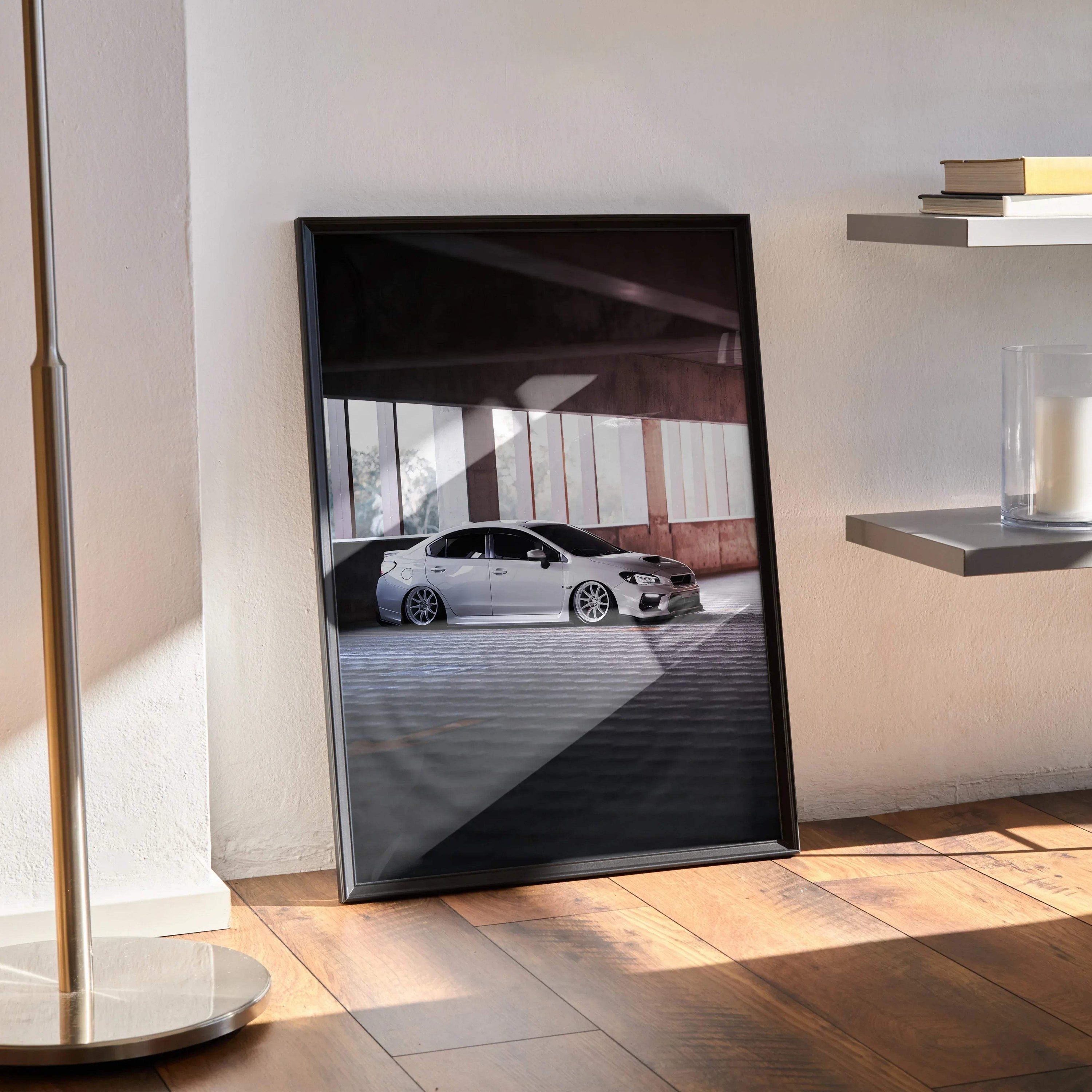 Subaru WRX car poster wall art with black frame leaning against wall on wooden floor.
