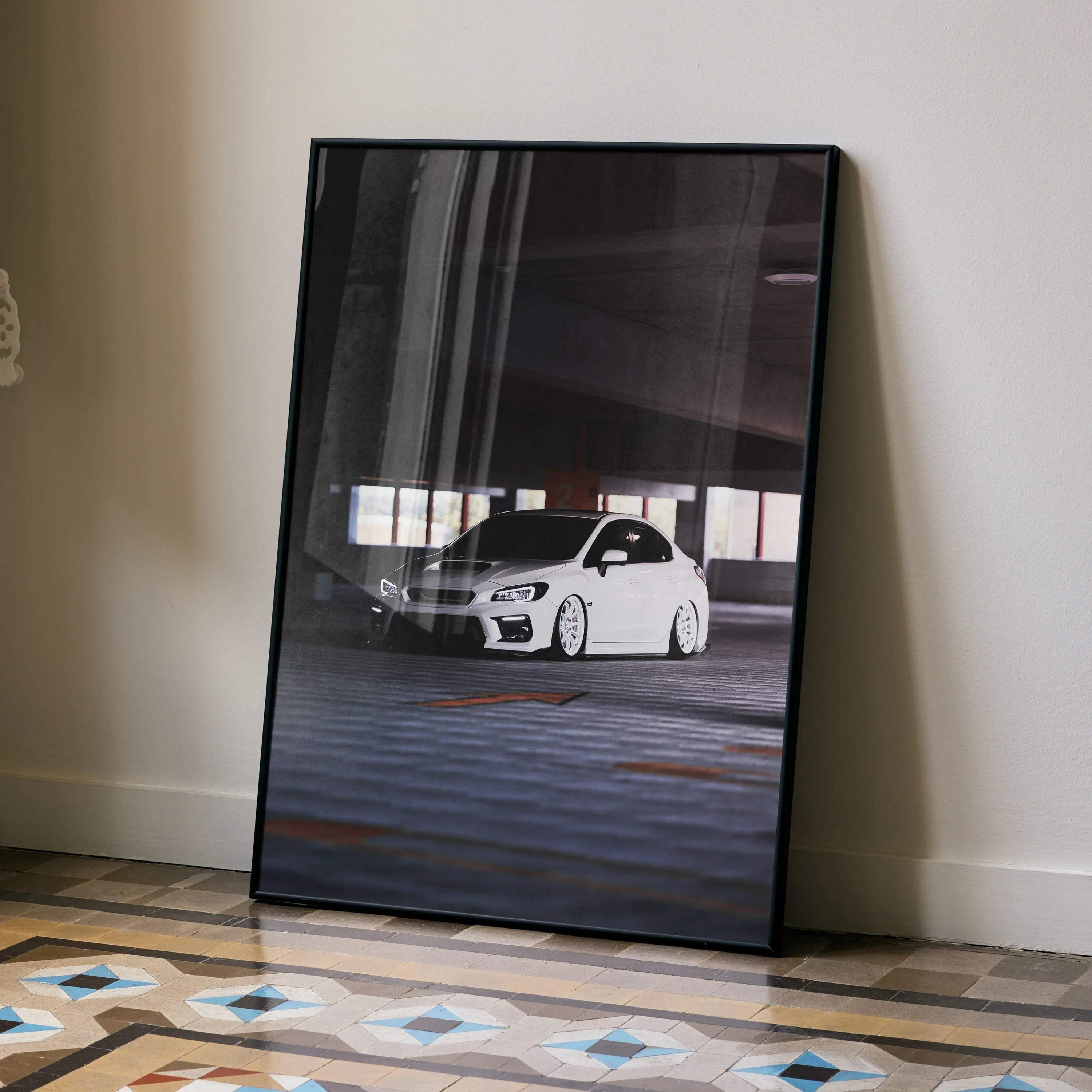 Subaru WRX white car poster in black frame leaning against wall, automotive wall art.