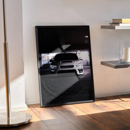 Subaru WRX front view poster wall art with sleek black background in black frame resting on wooden floor.