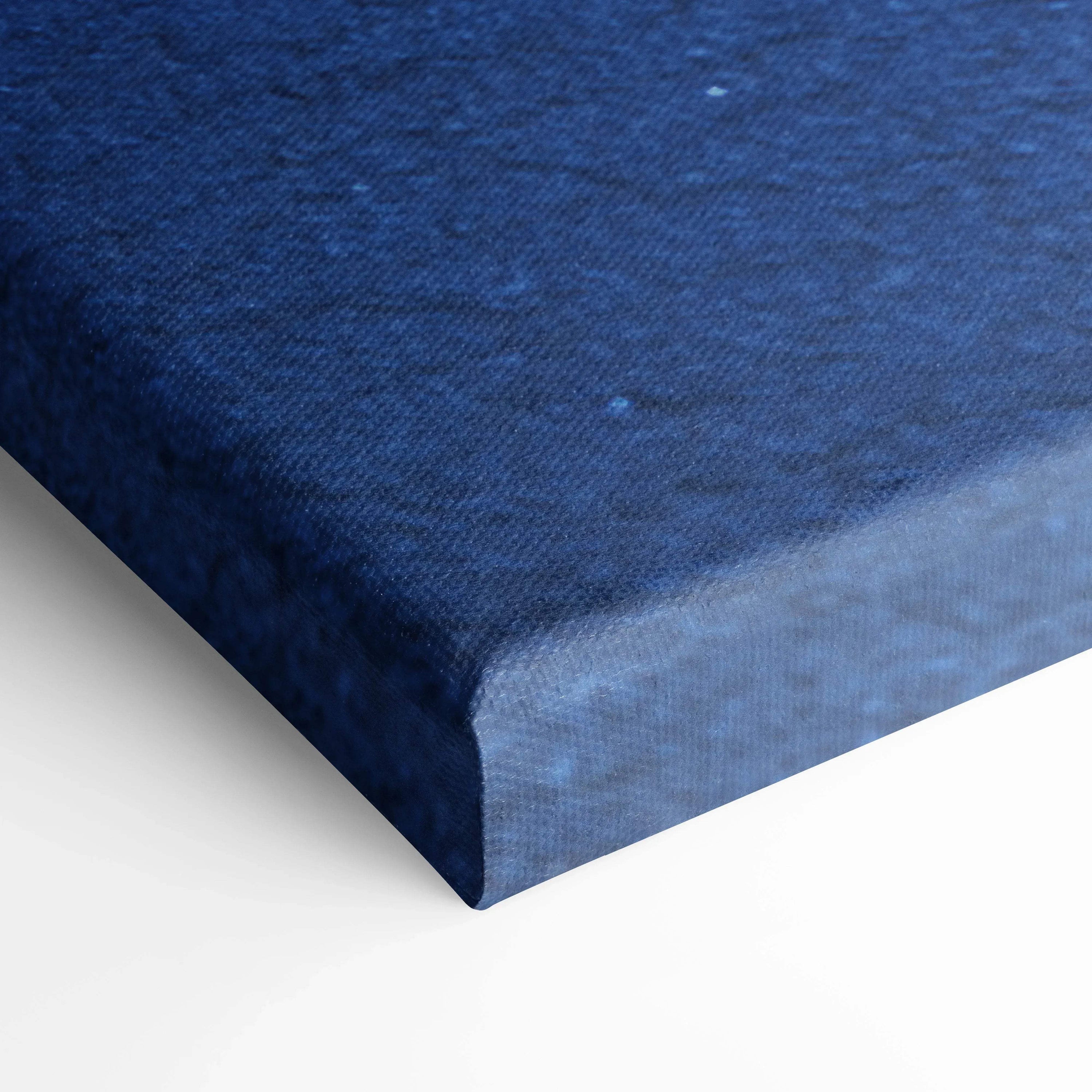 Close-up of textured navy blue canvas art corner with gallery wrap for wall art display.