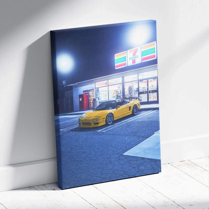 Vertical canvas art featuring a yellow Acura NSX parked outside a brightly lit 7-Eleven, modern wall art.