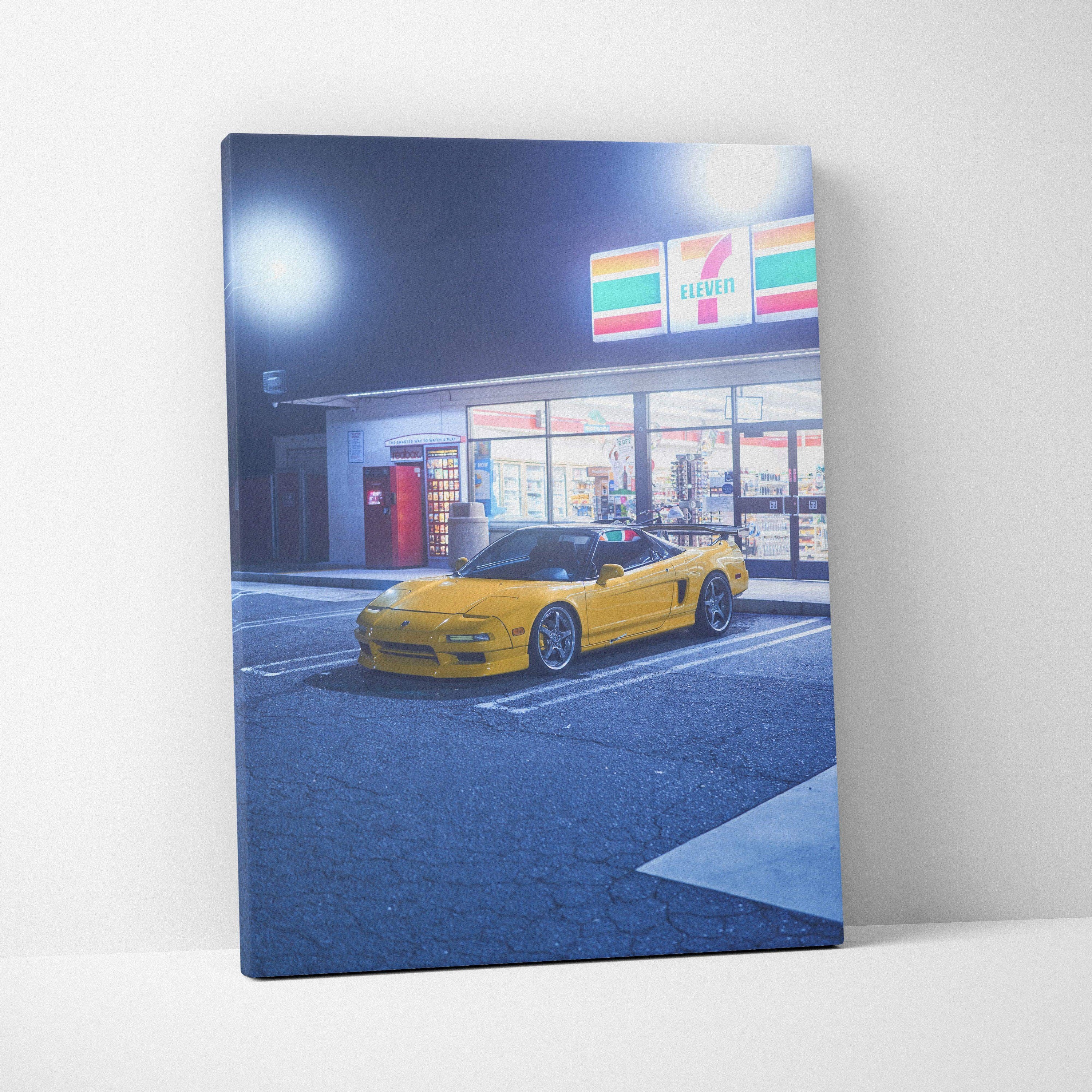 Yellow Acura NSX sports car parked in front of a lit 7-Eleven store at night canvas wall art.