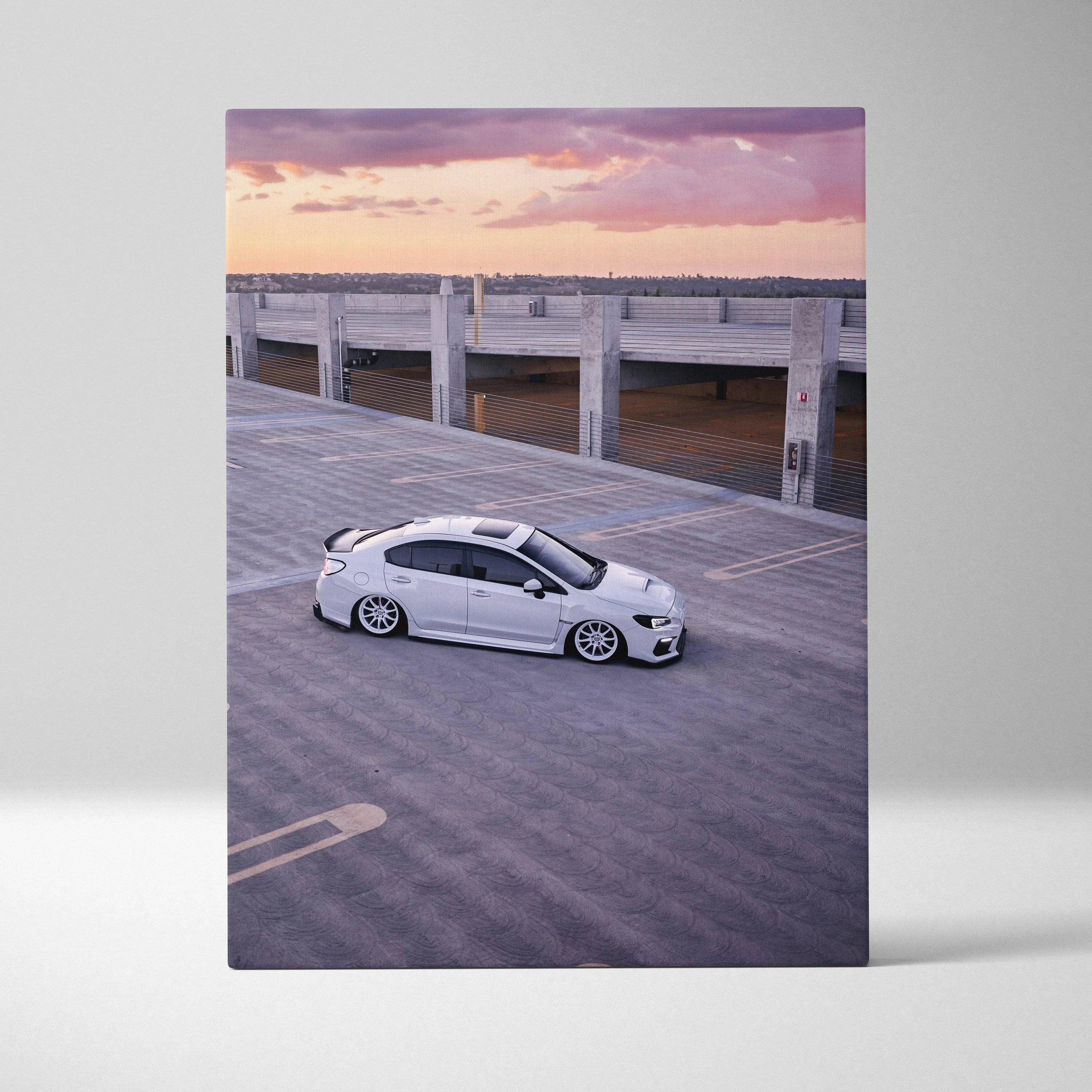 Vertical canvas wall art featuring a white Subaru WRX parked on rooftop at sunset.