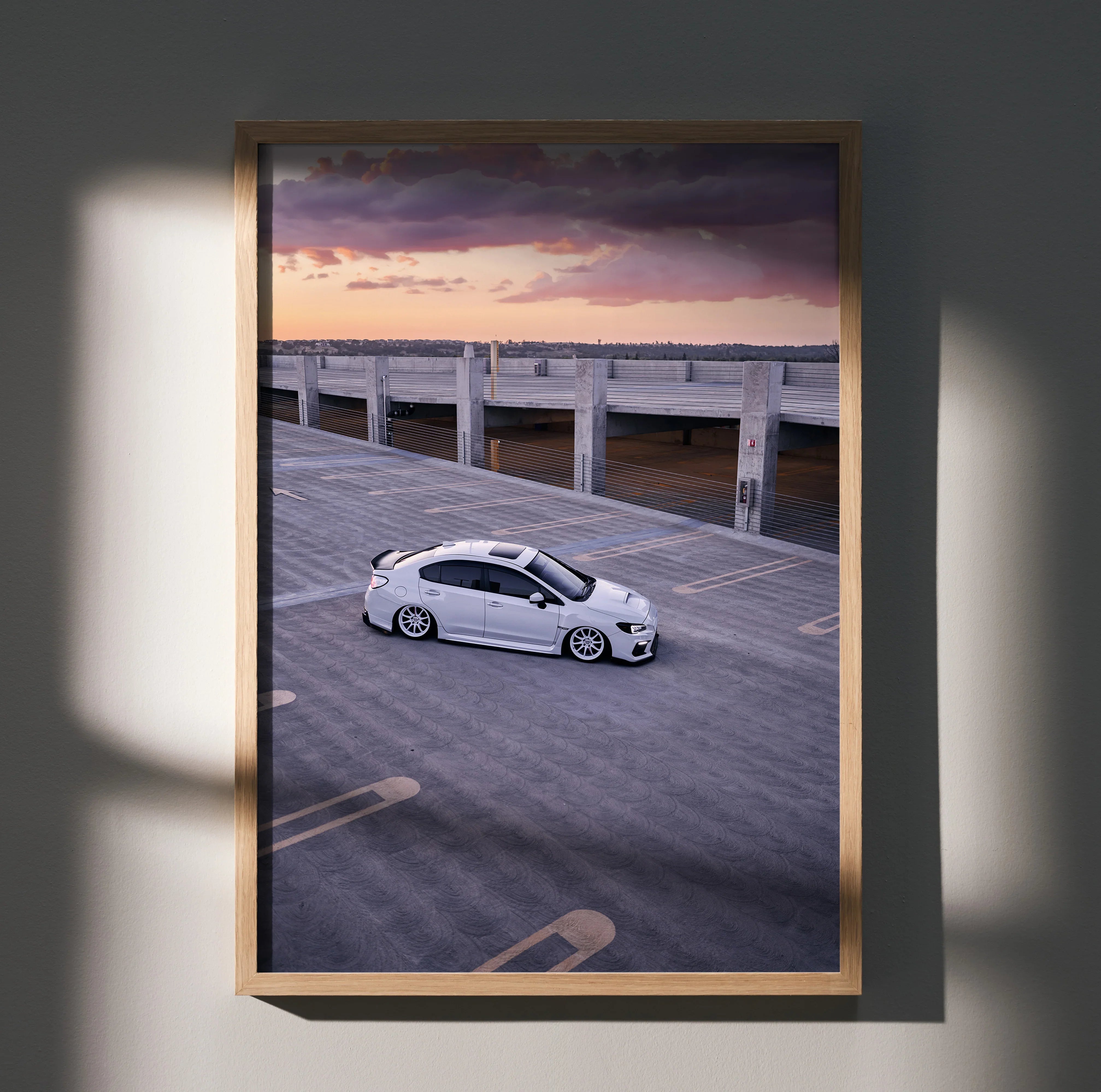Subaru WRX parked on wooden pier at sunset poster wall art with purple and orange sky.