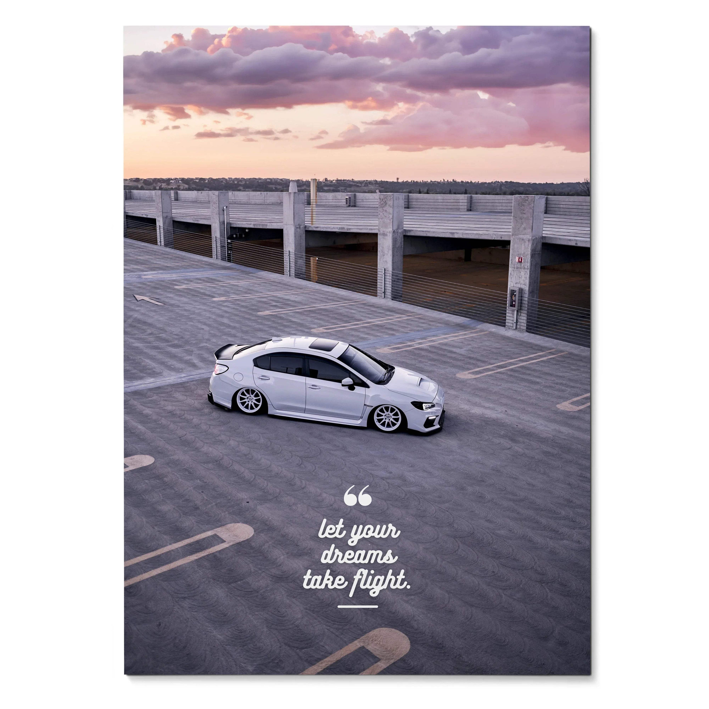 Poster wall art featuring a white Subaru WRX on an empty rooftop at sunset with motivational text.
