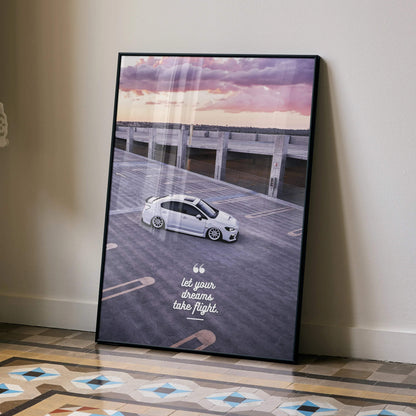 Subaru WRX parked at sunset with motivational quote poster wall art in black frame.