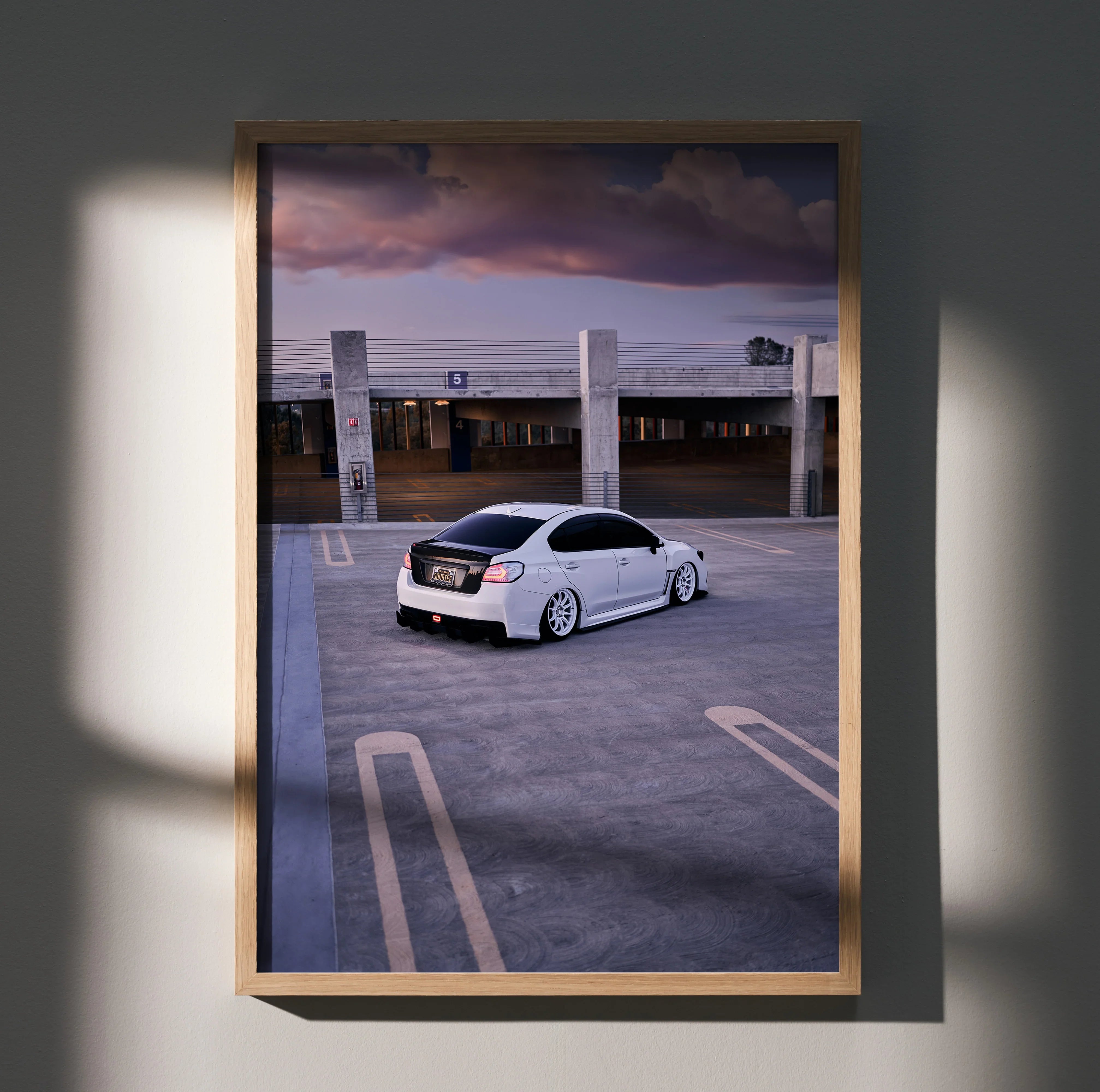 Subaru WRX white car poster wall art with dramatic sky and empty parking lot in wooden frame.