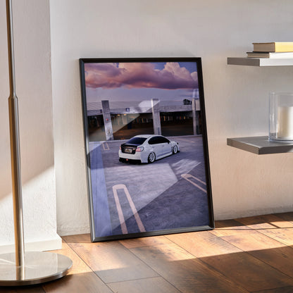 Subaru WRX poster wall art featuring a white car on rooftop with dramatic purple sky in black frame.