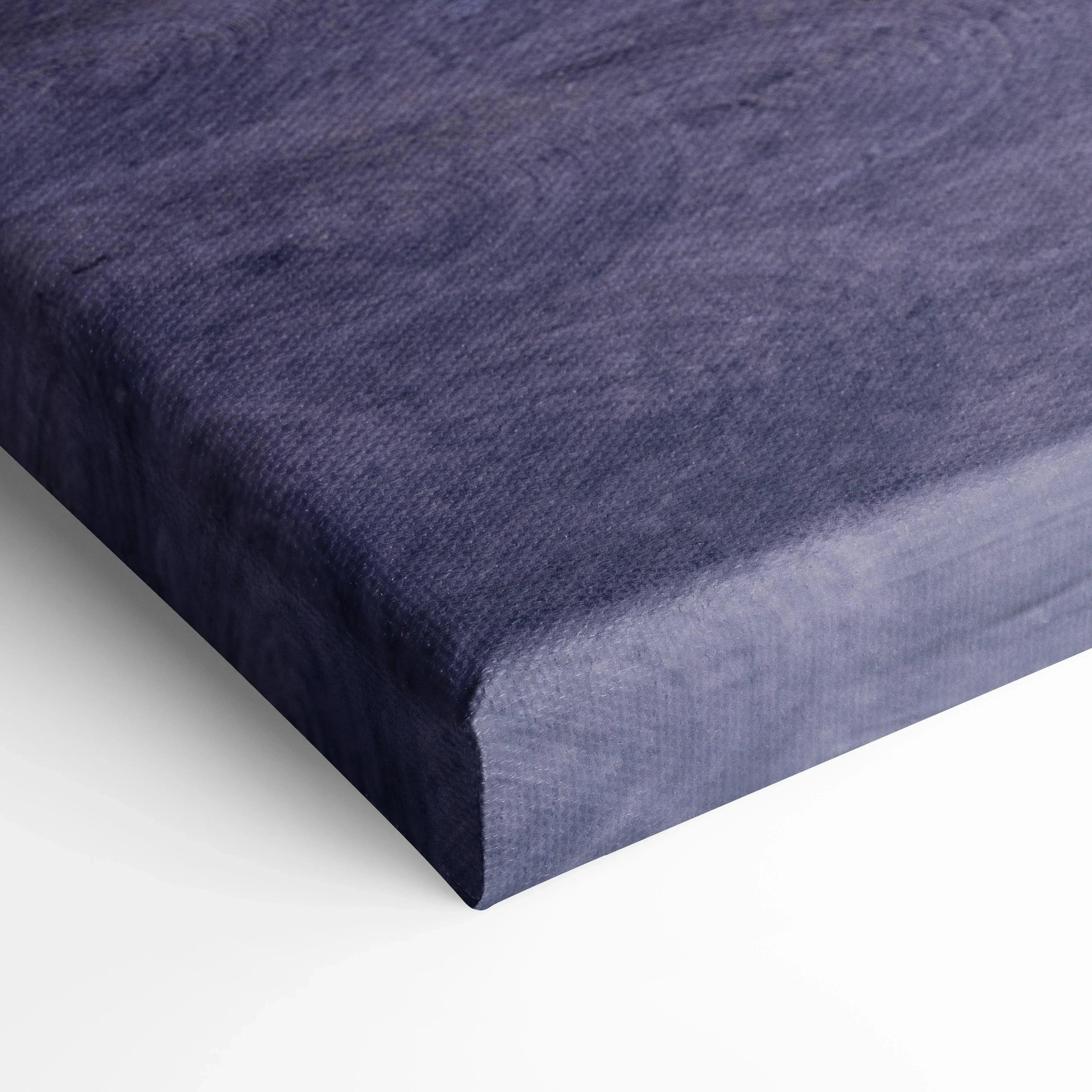 Close-up of textured navy blue canvas wall art with wrap-around edges and museum-quality finish.