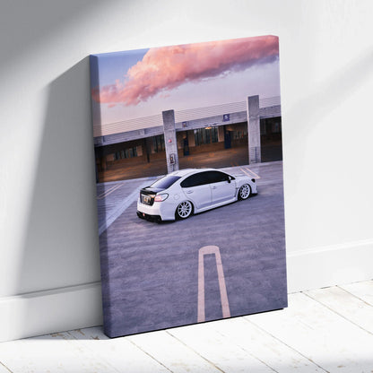 White Subaru WRX parked in an urban setting sunset scene canvas wall art.