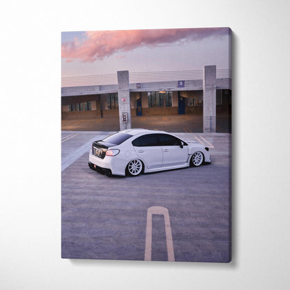Subaru WRX white car canvas wall art with urban parking lot background and sunset sky.
