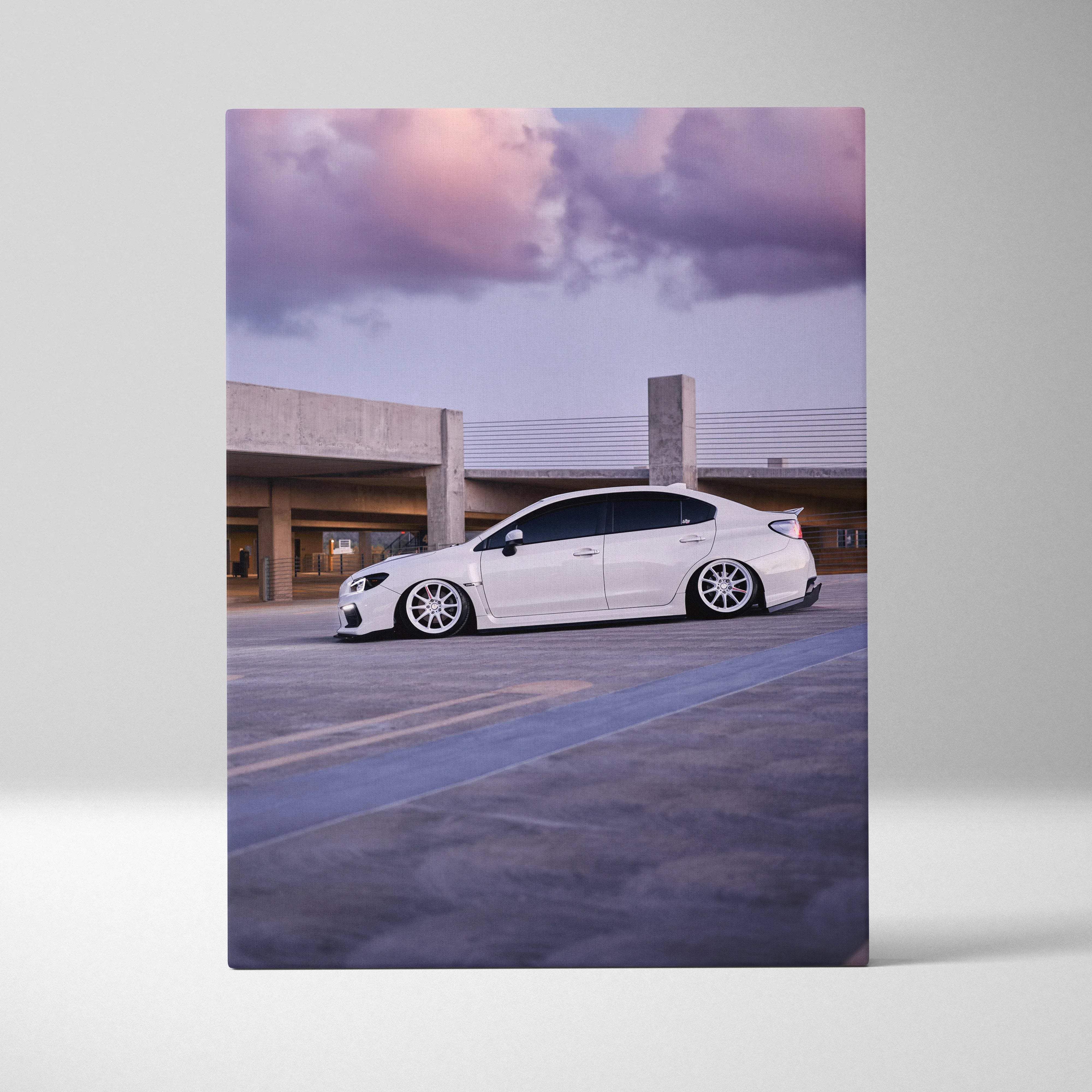 Canvas wall art featuring a white subaru wrx sedan with sleek lowered suspension and multi-spoke alloy wheels