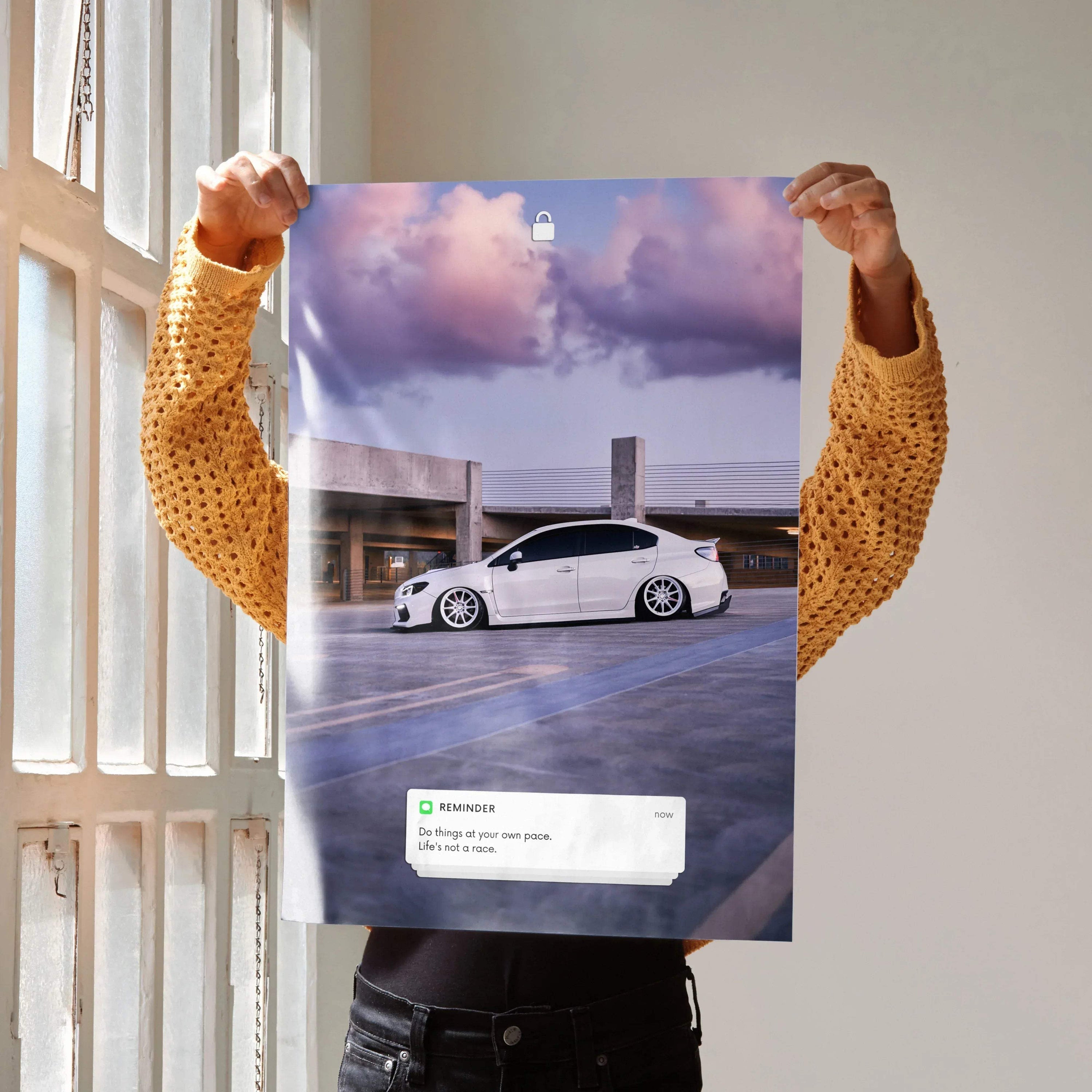 Poster wall art featuring a white Subaru WRX on a rooftop with a dramatic cloudy sky background and motivational text.