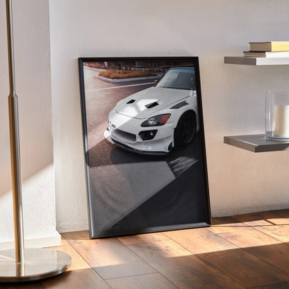 Honda S2000 white sports car poster leaning against wall, high-resolution automotive wall art in black frame.