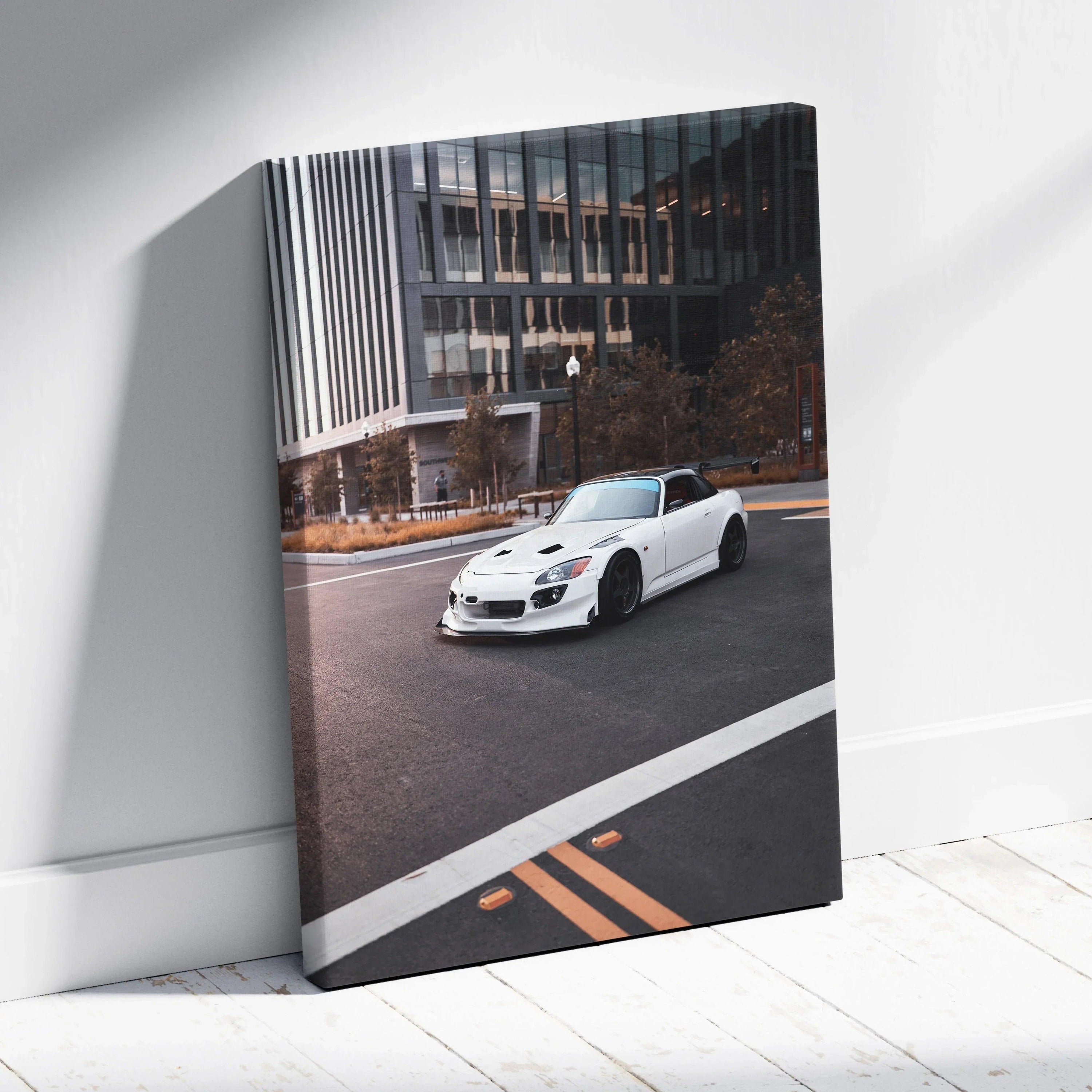 White Honda S2000 sports car on urban street canvas wall art with modern building backdrop.