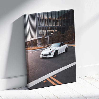White Honda S2000 sports car on urban street canvas wall art with modern building backdrop.