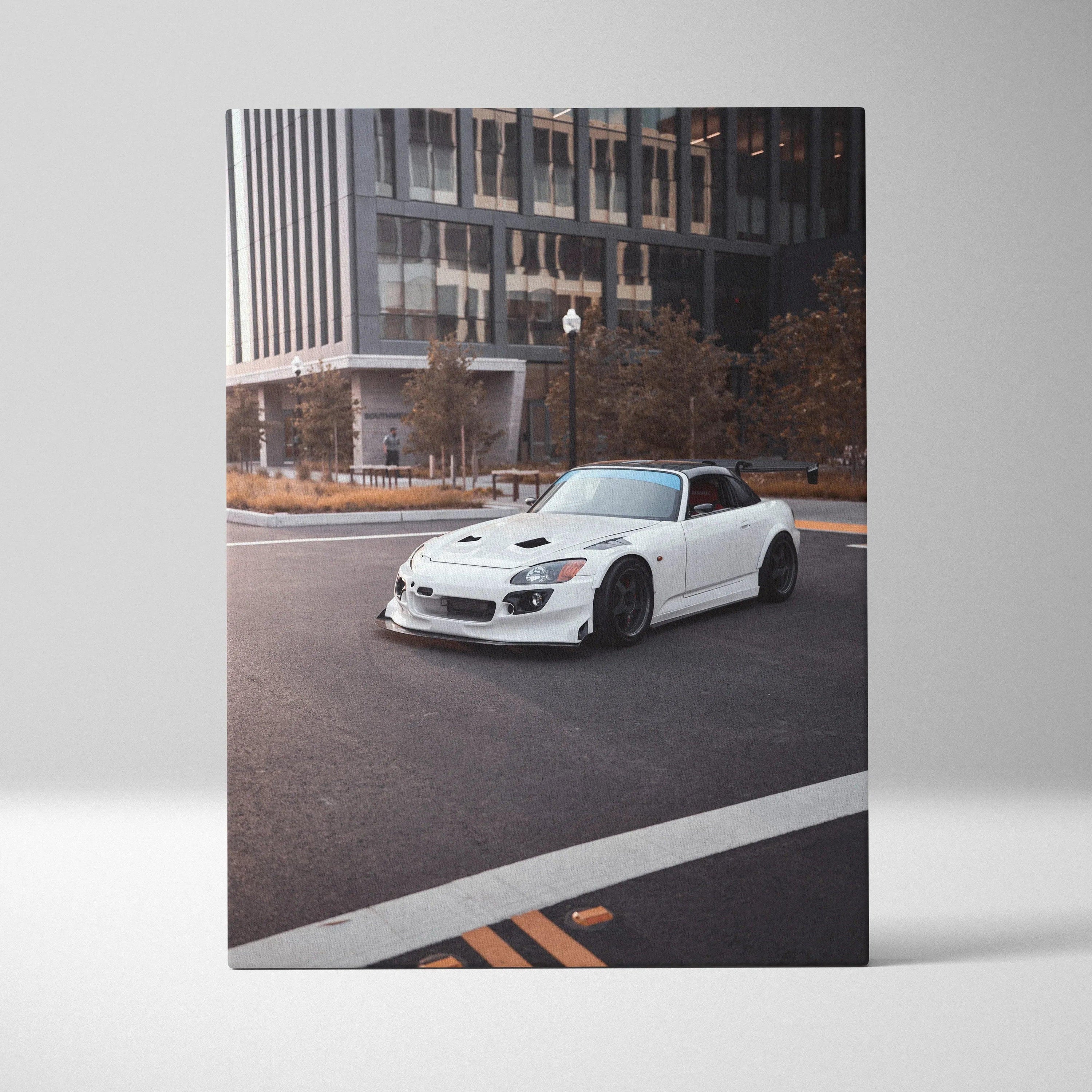White Honda S2000 parked on urban street canvas wall art with cityscape background.