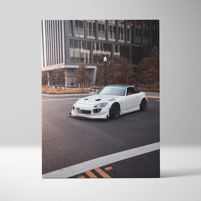 White Honda S2000 parked on urban street canvas wall art with cityscape background.