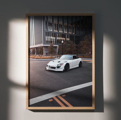 White Honda S2000 sports car on city street poster wall art in wooden frame.