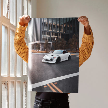 Honda S2000 poster wall art featuring white sports car on urban street with modern buildings in background.